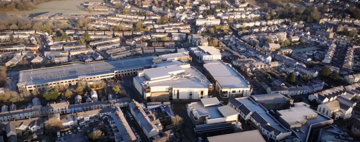 Wide aerial drone view of Carmarthen town centre with the former Debenhams building and multi-storey car park at its centre