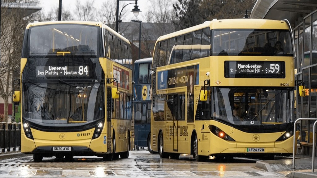 Two yellow Bee Network double-decker buses at Oldham bus station in Greater Manchester