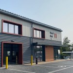 The new grey and orange clad business units at Beechwood Industrial Estate in Llandeilo, with roller doors open and a bike shelter outside