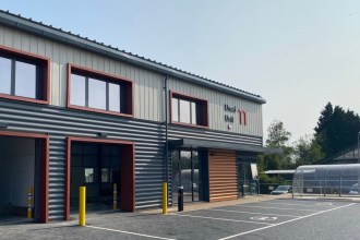 The new grey and orange clad business units at Beechwood Industrial Estate in Llandeilo, with roller doors open and a bike shelter outside