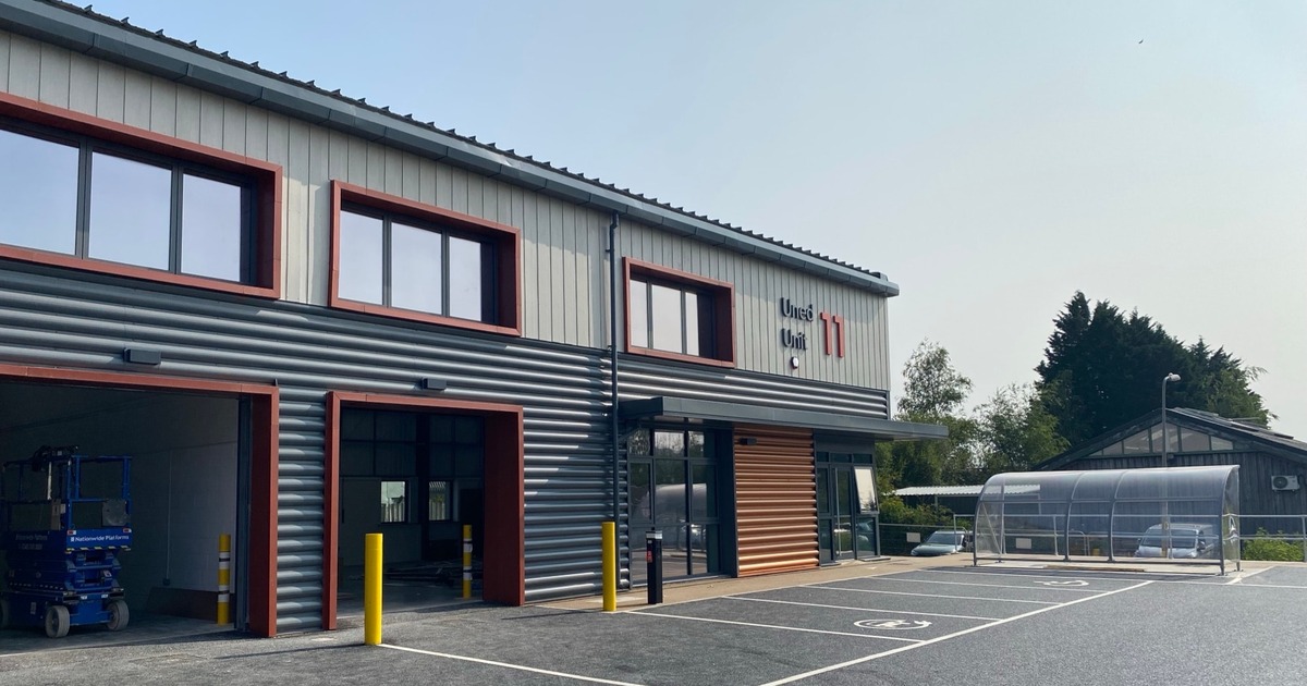 The new grey and orange clad business units at Beechwood Industrial Estate in Llandeilo, with roller doors open and a bike shelter outside