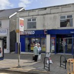 The Betfred betting shop on Woodfield Street in Morriston with a bus stop outside
