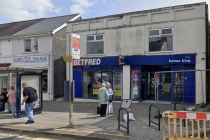 The Betfred betting shop on Woodfield Street in Morriston with a bus stop outside