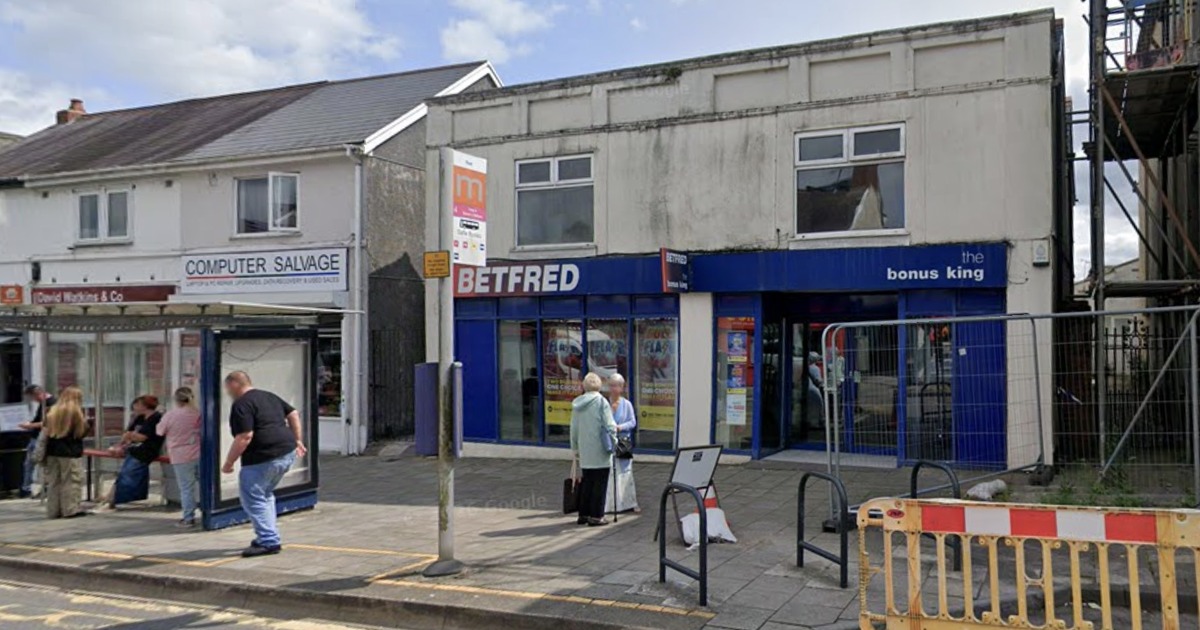 The Betfred betting shop on Woodfield Street in Morriston with a bus stop outside