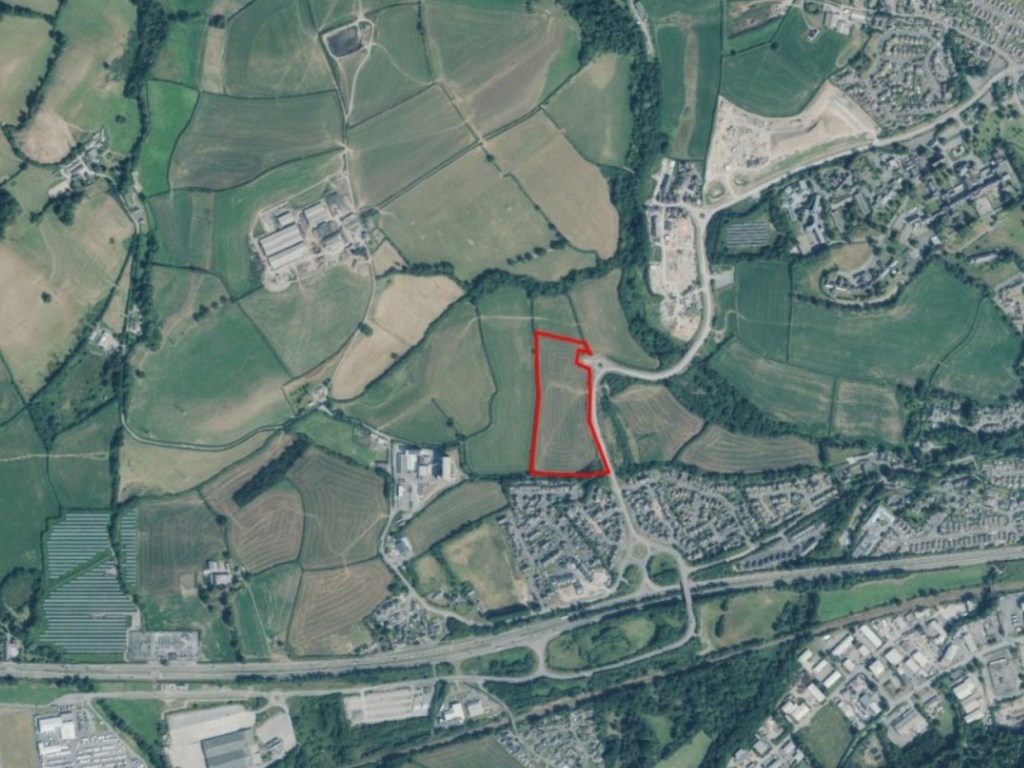 Aerial photograph of the fields west of Carmarthen with the 84-home application site outlined in red beside the link road and the A40