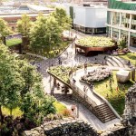 Aerial artist's impression of Castle Square Gardens, showing lawns, planted terraces, a fountain, a big screen and a copper-clad pavilion beside the castle ruins