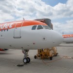 Two easyJet aircraft in orange and white livery parked on an airport apron