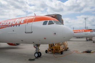 Two easyJet aircraft in orange and white livery parked on an airport apron