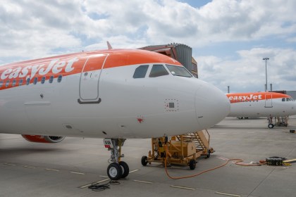 Two easyJet aircraft in orange and white livery parked on an airport apron