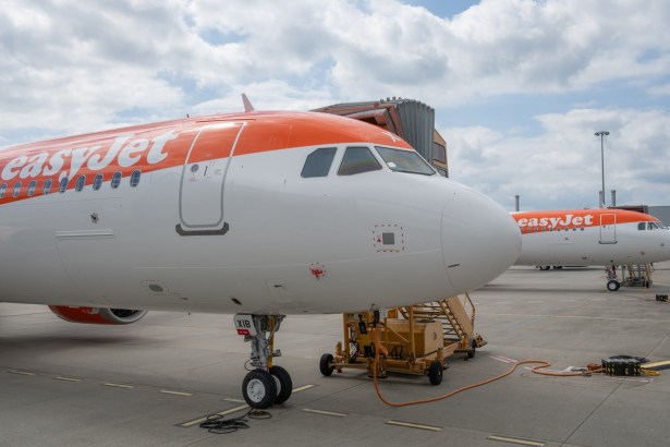 Two easyJet aircraft in orange and white livery parked on an airport apron