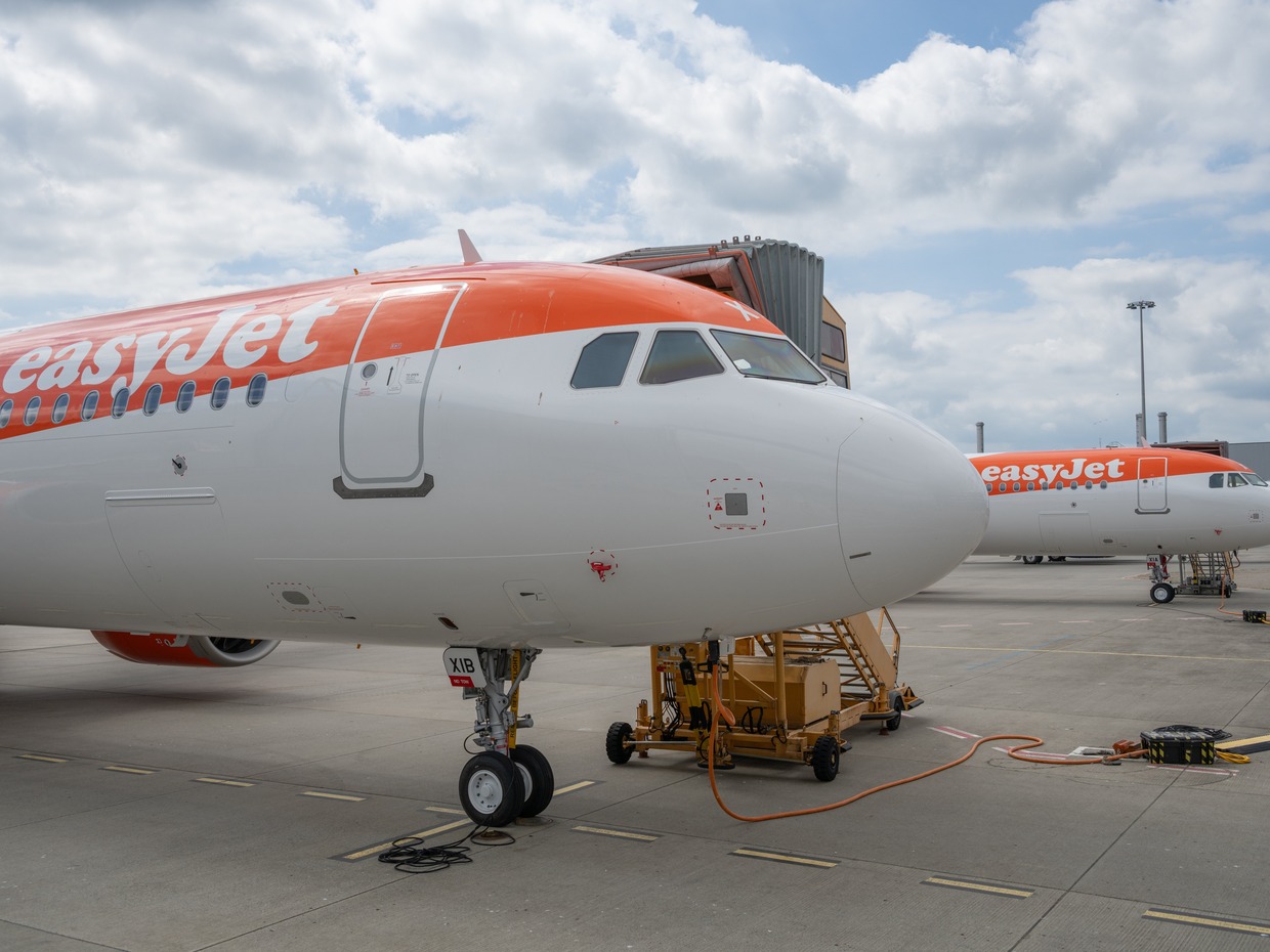 Two easyJet aircraft in orange and white livery parked on an airport apron