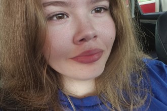 Erin O'Keefe, a 16-year-old with long light brown hair wearing a blue top, photographed in a car
