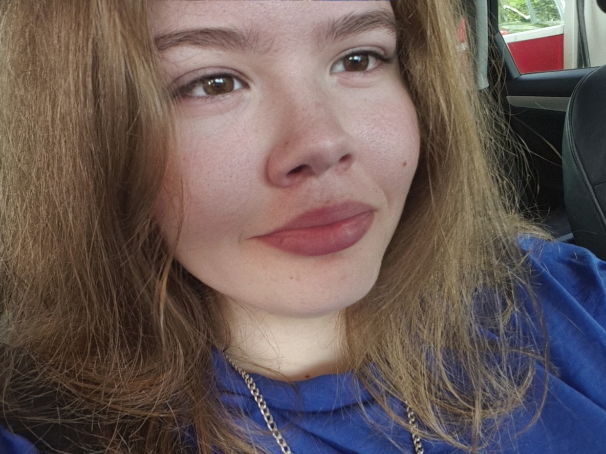 Erin O'Keefe, a 16-year-old with long light brown hair wearing a blue top, photographed in a car