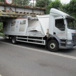 A Likewise Floors lorry with its roof torn open wedged under the Trafle Mill railway bridge in Gowerton