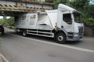 A Likewise Floors lorry with its roof torn open wedged under the Trafle Mill railway bridge in Gowerton