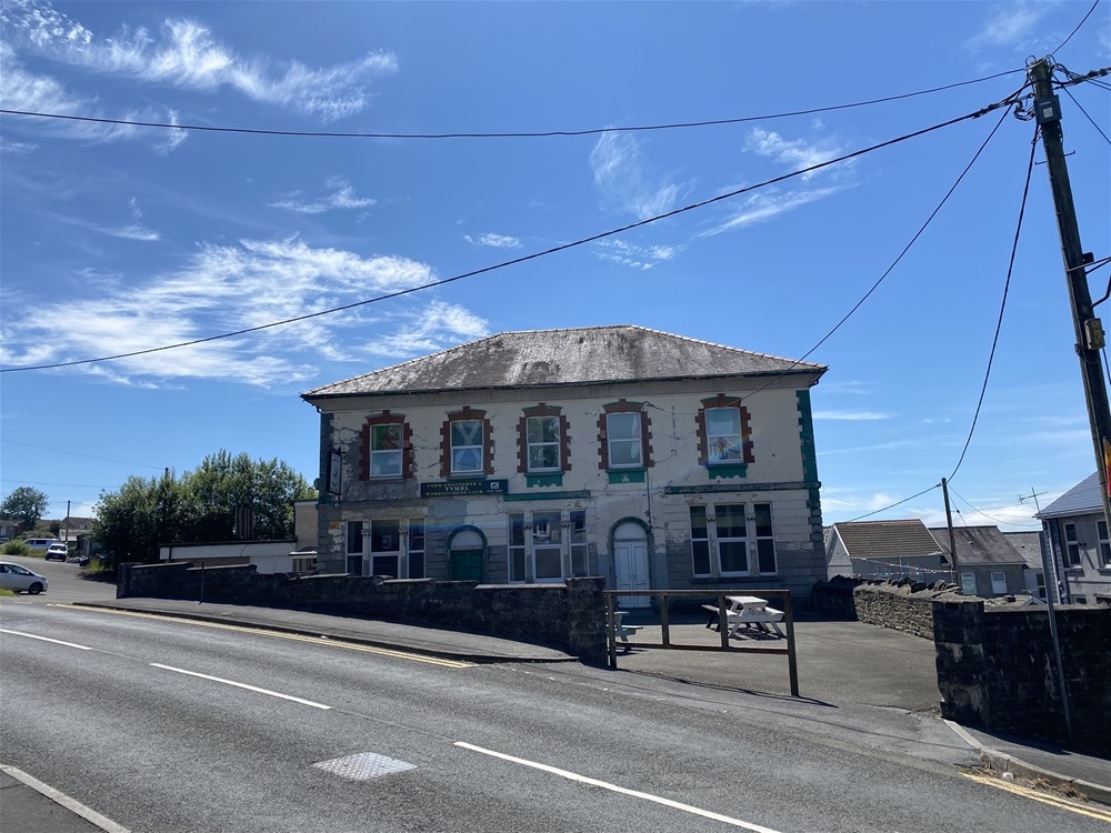 The Great Mountain Workingmen's Club, a two-storey rendered building on the main road through Tumble