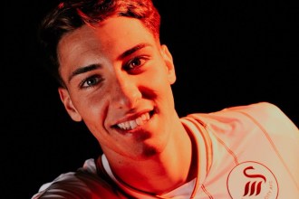 Swansea City new signing Tiago Parente in the new home shirt, with the circular club badge showing the Swansea City AFC lettering