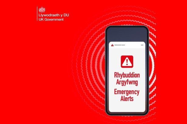 The UK Government Emergency Alerts graphic showing a phone displaying Rhybuddion Argyfwng and Emergency Alerts on a red background