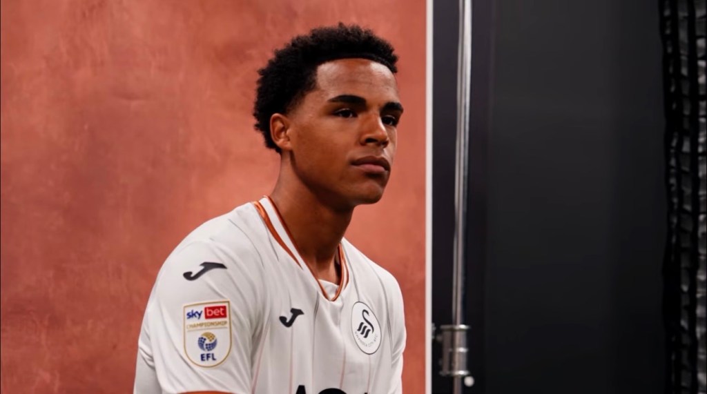 Tom Iorpenda in profile wearing the Swansea City home shirt at his signing shoot