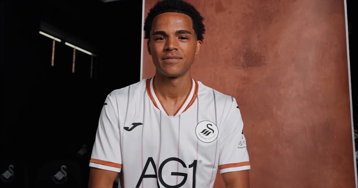 Tom Iorpenda facing the camera in the Swansea City home shirt at his signing photo shoot