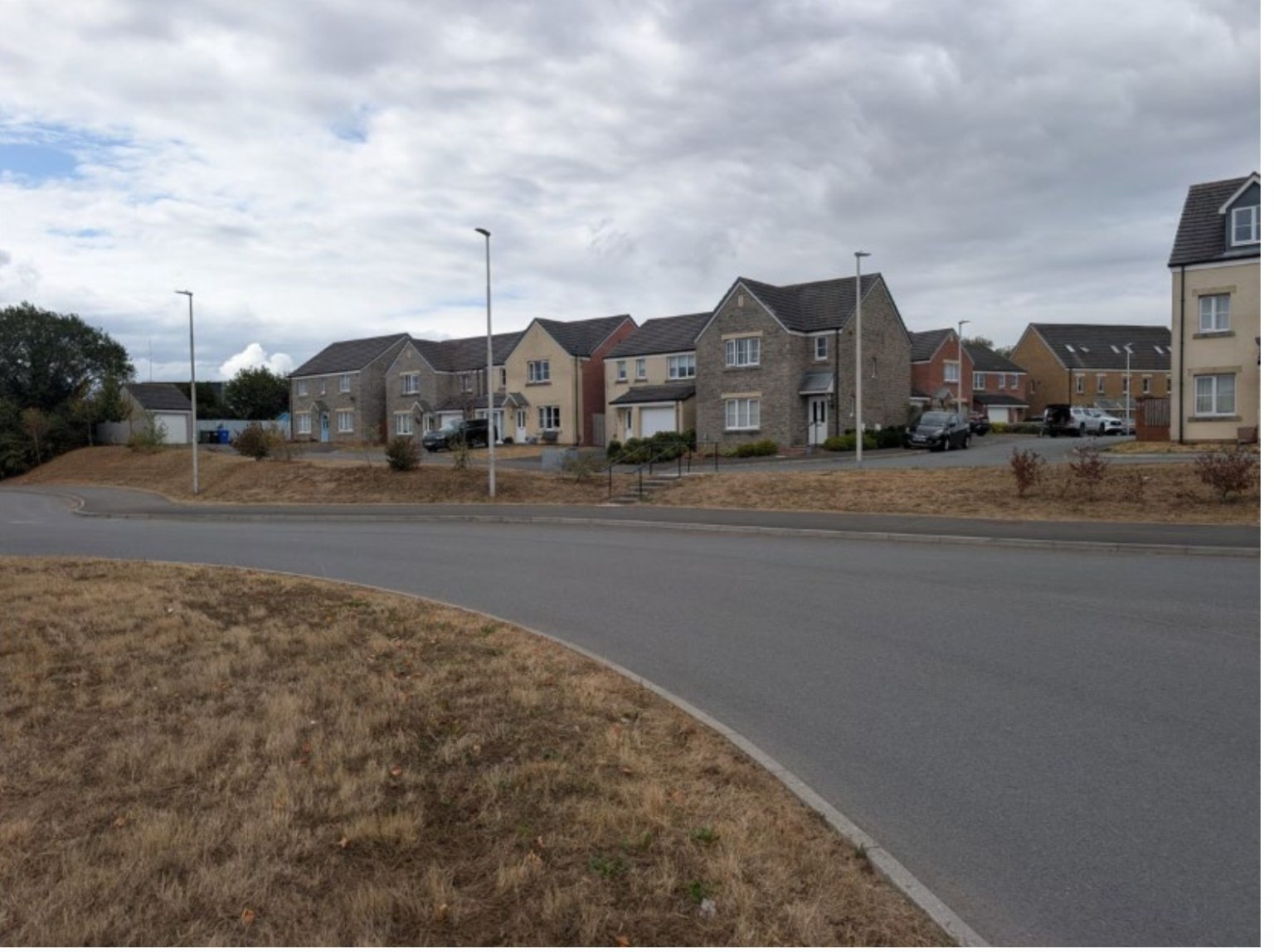 A row of new stone and render houses on the Maes Pedr estate in Carmarthen West