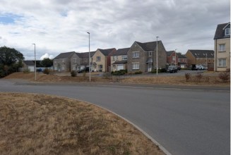 A row of new stone and render houses on the Maes Pedr estate in Carmarthen West