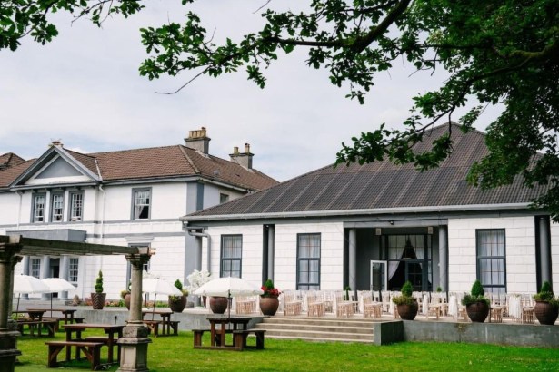Manor Park Country House in Clydach, a white Italianate mansion with a terrace laid out for a wedding ceremony