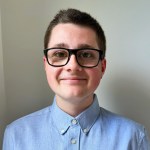 Mason Jones, a teenager in glasses and a blue shirt, smiling at the camera