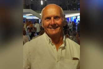 Melvin Austin, a 73-year-old man from Ystalyfera, smiling in a white shirt