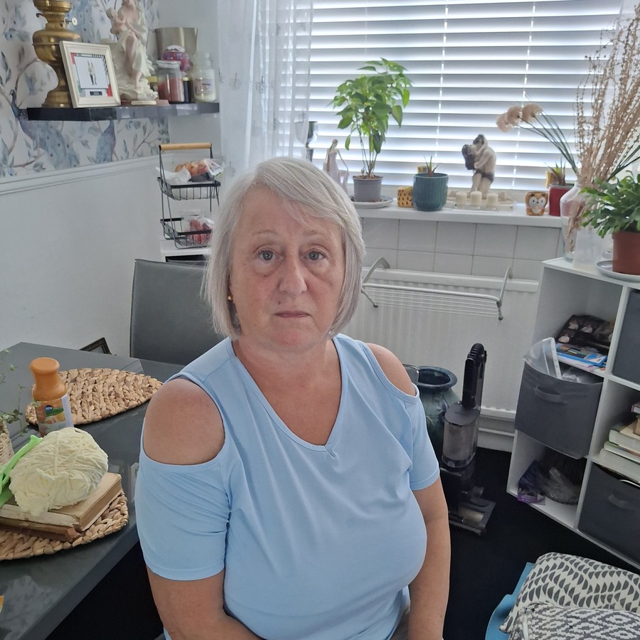 Heather Allen sitting at a table in her home in Brynmelyn