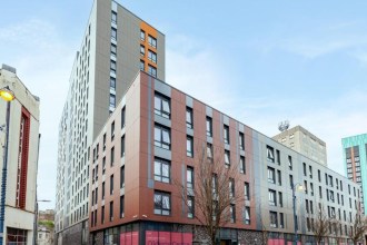The Oldway Centre student block on High Street, Swansea, with its tower rising behind the lower High Street extension