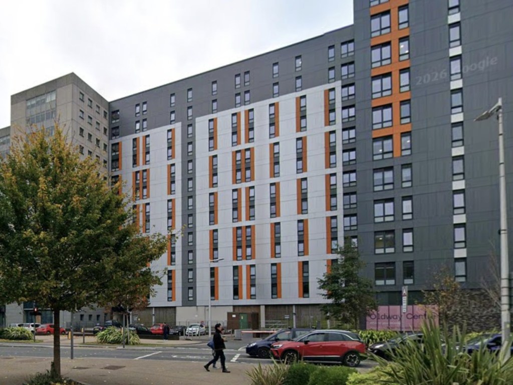 The Oldway Centre student block on High Street, Swansea, seen from street level with cars parked outside
