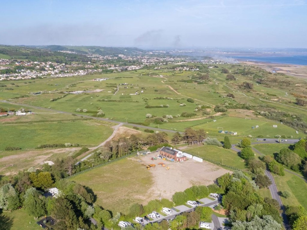 Aerial view of the Old Pump House and its cleared plot with Pembrey Country Park, Cefn Sidan and the estuary beyond