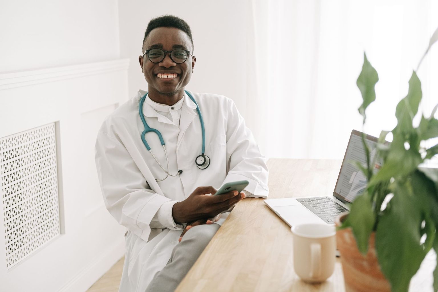 a smiling man holding a smartphone