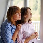 women looking out window and dreaming