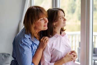 women looking out window and dreaming