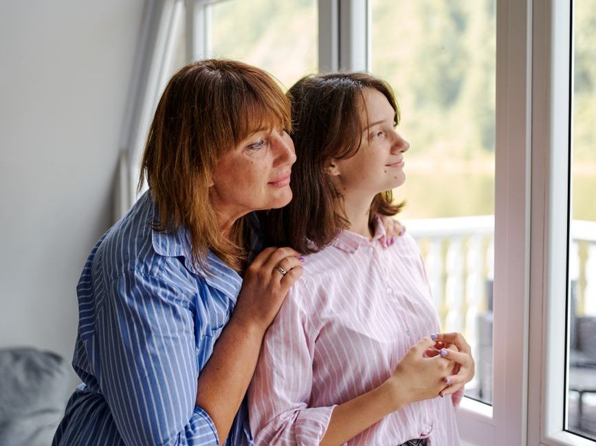 women looking out window and dreaming