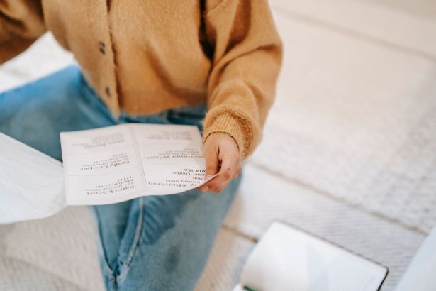 A student reads a printed results sheet, in a posed stock photograph