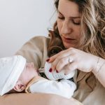 mother bottle feeding infant baby