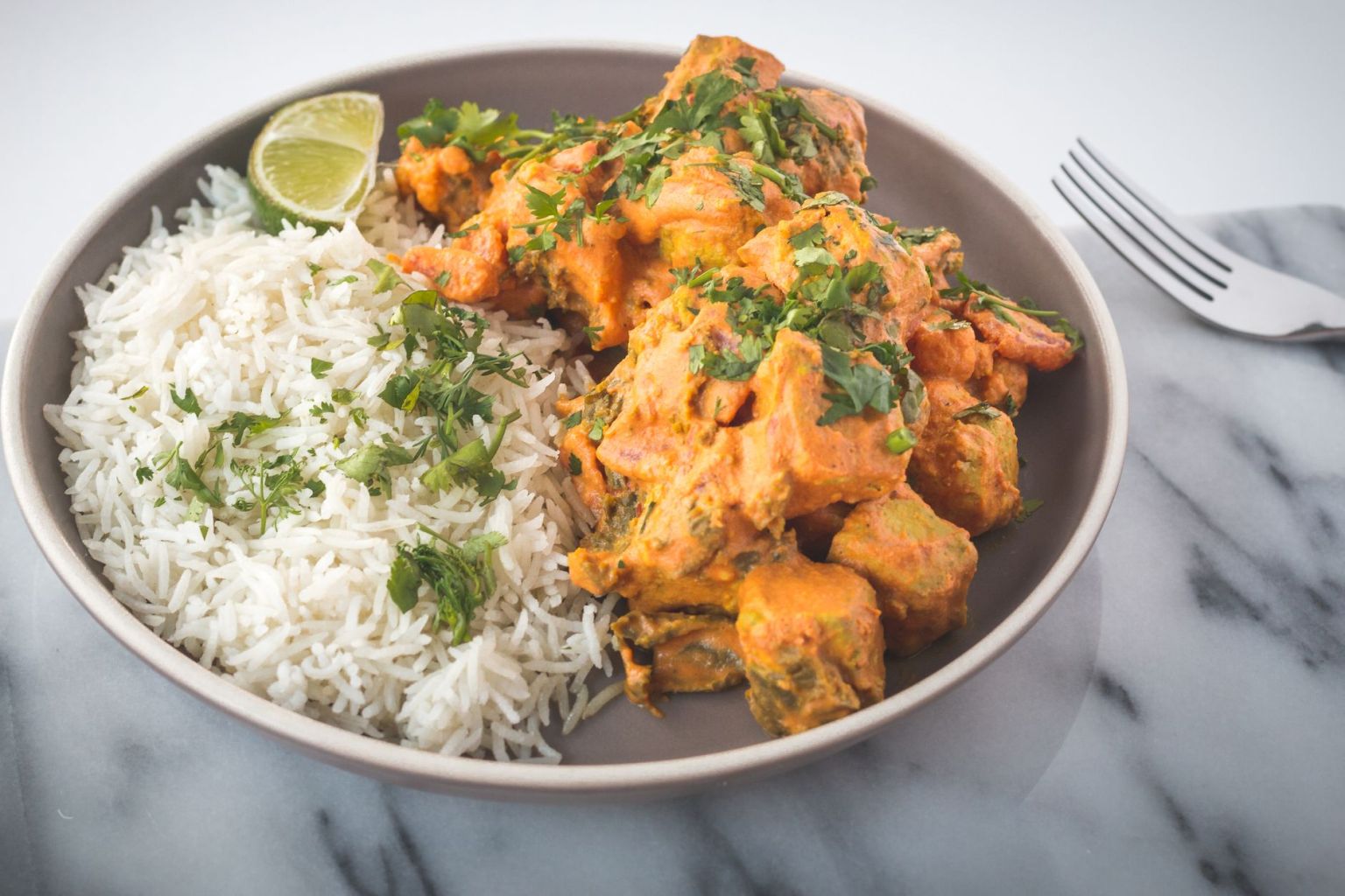A cooked Indian-style meal served on a grey ceramic plate