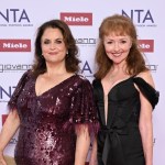 Ruth Jones in a sequinned burgundy dress and Melanie Walters in a black dress, standing together at the National Television Awards