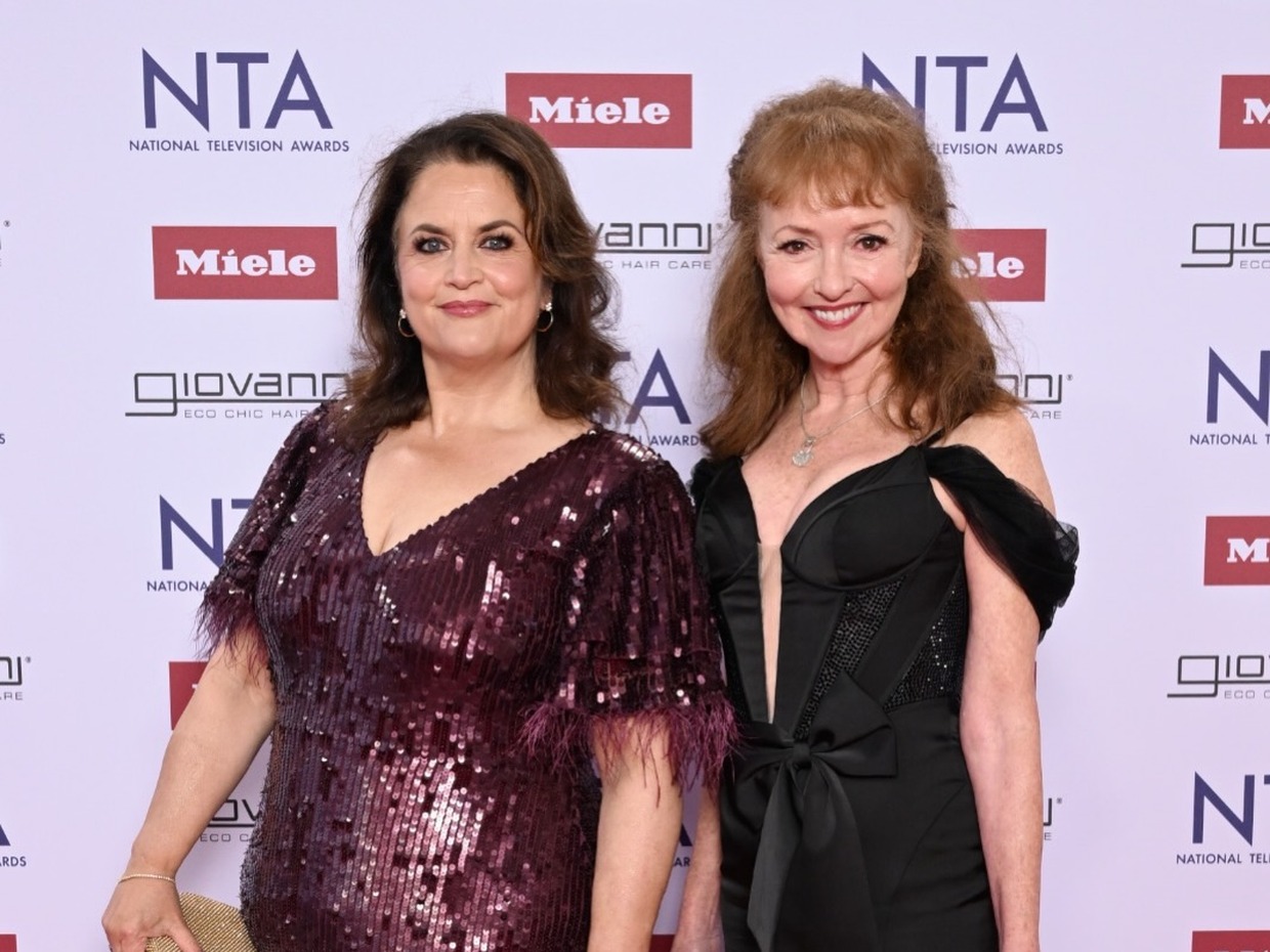 Ruth Jones in a sequinned burgundy dress and Melanie Walters in a black dress, standing together at the National Television Awards