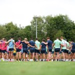 Scarlets players gathered in a huddle on the training field.