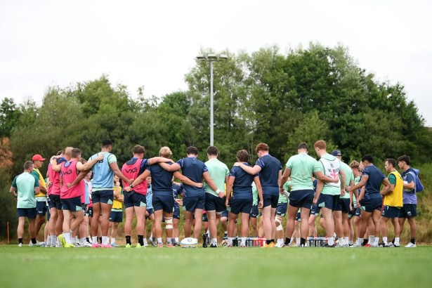 Scarlets players gathered in a huddle on the training field.
