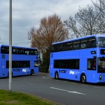 Two double-decker buses in blue South West Wales Network livery with Swansea on the destination board, a Swansea Bay News mock-up
