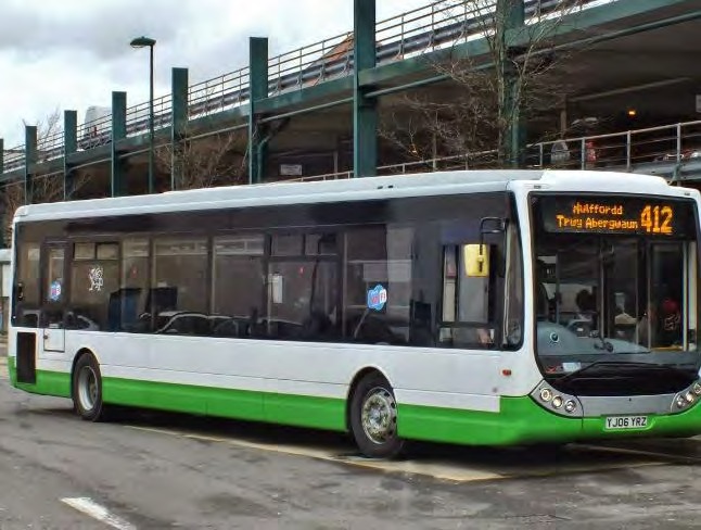 A green and white 412 bus to Haverfordwest via Fishguard parked beneath a multi-storey car park