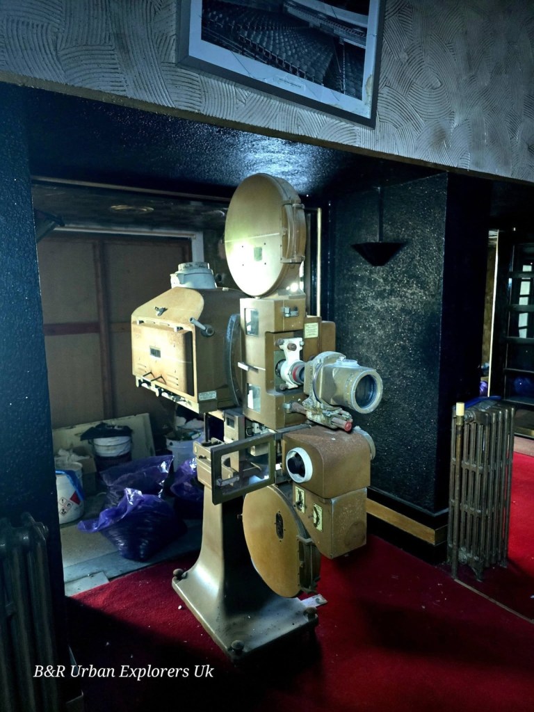 A vintage cinema projector on a stand inside the derelict Theatr Elli