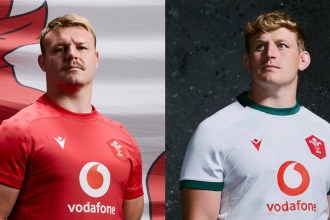 Two Wales players wearing the all-red dragon-patterned home shirt and the white slate-inspired alternate jersey