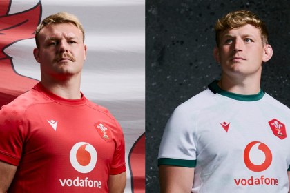Two Wales players wearing the all-red dragon-patterned home shirt and the white slate-inspired alternate jersey