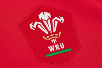 Close-up of the red WRU crest with the Prince of Wales feathers on the new red home jersey